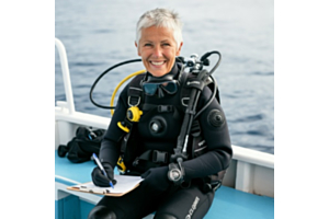 Senior female scuba diving sitting on a dive boat