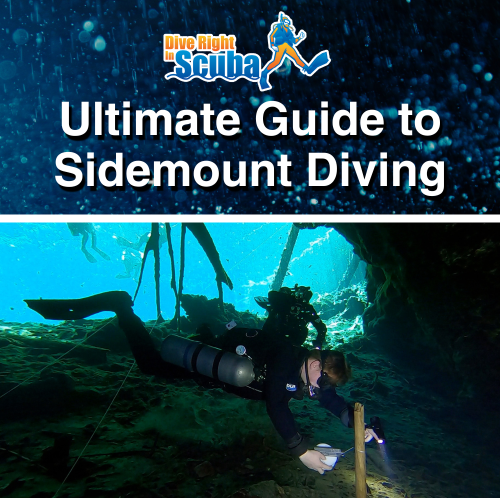 A sidemount diver in a wreck underwater with lights illuminating his path