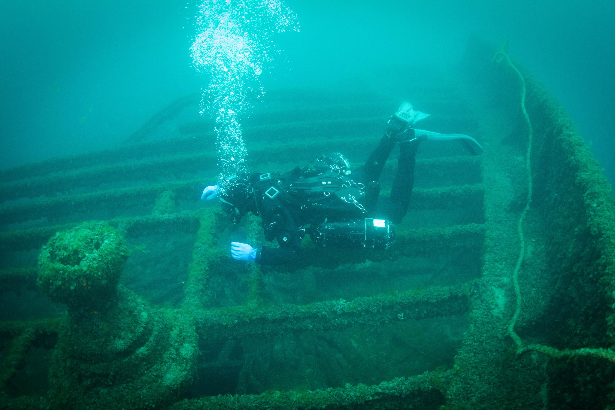 Diver exploring a shipwreck underwater