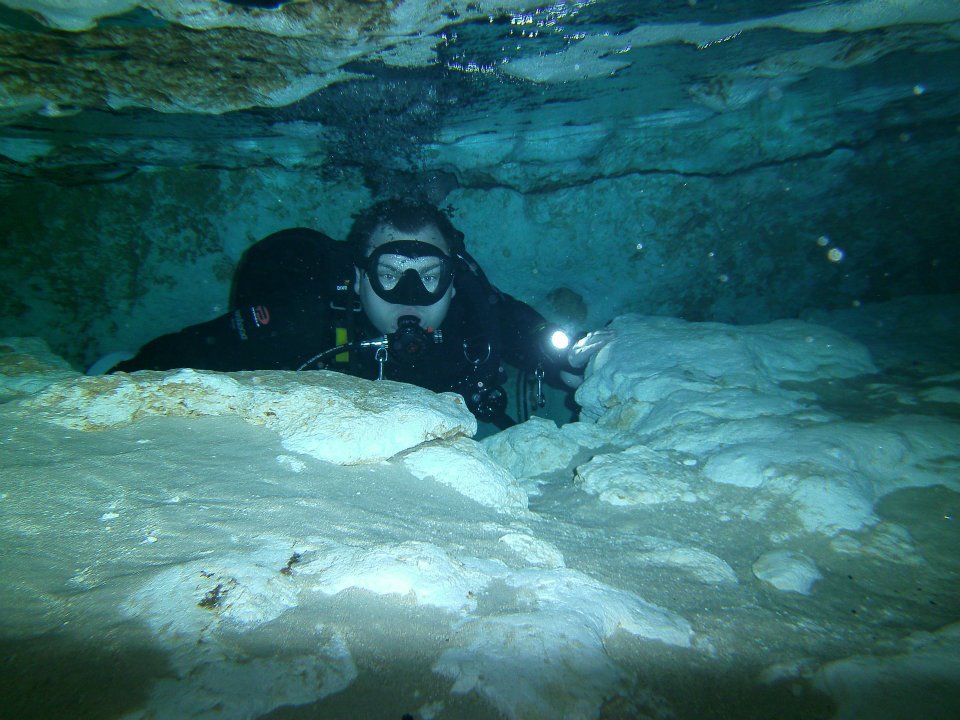 Diver underwater wearing a sidemount system