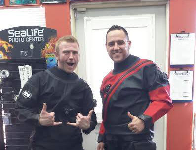 Two guys showing of their drysuits