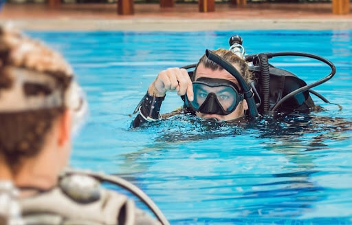 Diving instructor demonstrating for a student