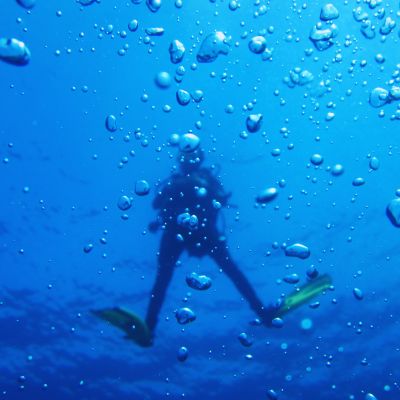 A diver underwater surrounded by bubbles