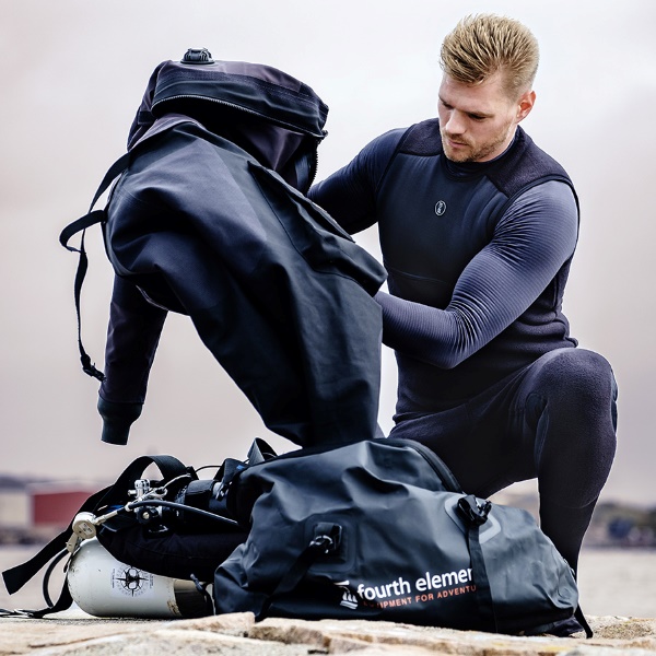 Diver examing his divesuit while wearing dive undergarments