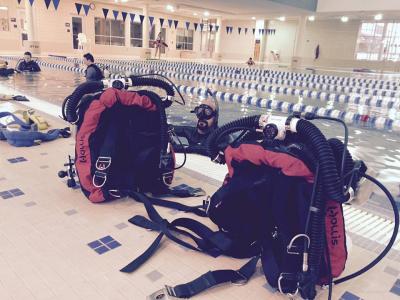 BCDs at the edge of an indoor pool