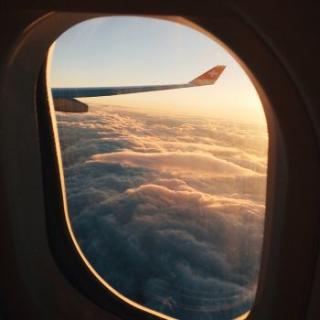 Looking out the window of an airplane while the plane is in flight