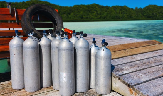 Several metal tanks on a wooden dock