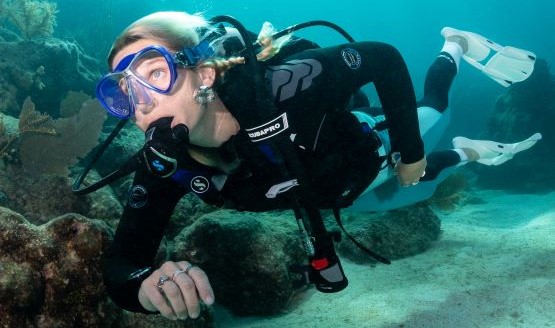 A female diver underwater with full scuba gear